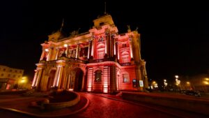 a large building lit up with red lights