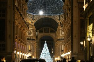 a car driving down a street next to a christmas tree