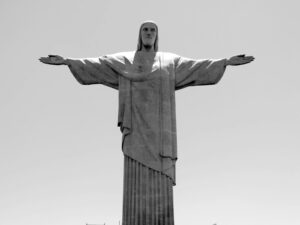 Black and white photo of the iconic Christ the Redeemer statue in Rio de Janeiro, Brazil.