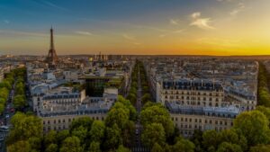 Scenic aerial view of Paris featuring the Eiffel Tower at sunset, capturing the tranquil cityscape.