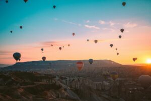 Colorful hot air balloons soaring over Cappadocia at sunrise, Turkey.