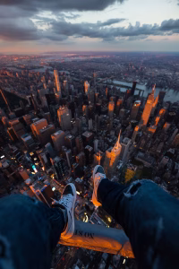 Stunning aerial view of New York City skyline at sunset, capturing city lights and vibrant atmosphere.