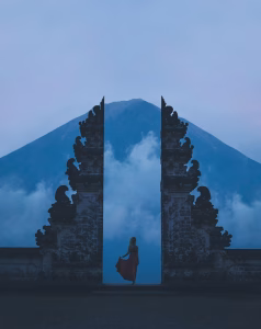 woman in between on concrete landmarks near white clouds