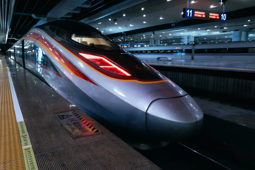 A sleek high-speed train sits at the station