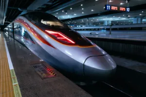 A sleek high-speed train sits at the station